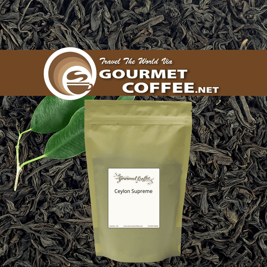 A stand-up pouch of Gourmet Coffee.net Ceylon Supreme loose-leaf tea placed over a background of dark tea leaves, with two green leaves and a brown banner at the top featuring the Gourmet Coffee.
