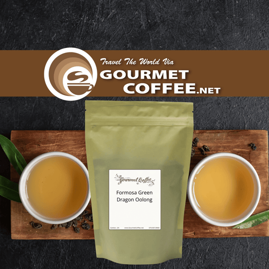 A stand-up pouch of Gourmet Coffee Formosa Green Dragon Oolong tea centered on a wooden board, with two white cups of brewed tea on both sides and a Gourmet Coffee.net banner across the top.